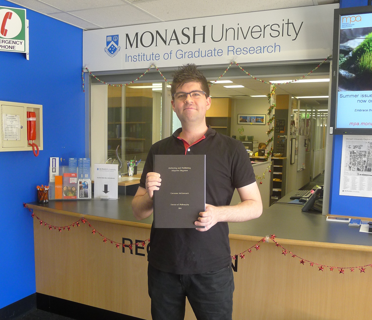 Me submitting my thesis at the Monash Institute of Graduate Research office.